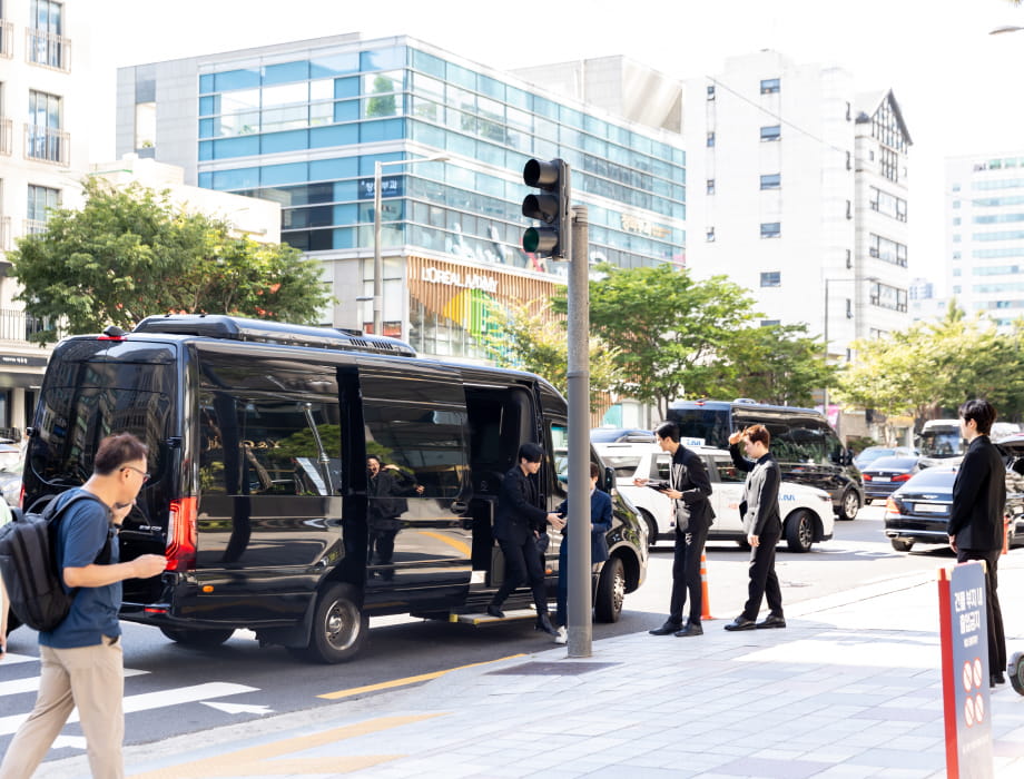 VIP exiting a black luxury van.