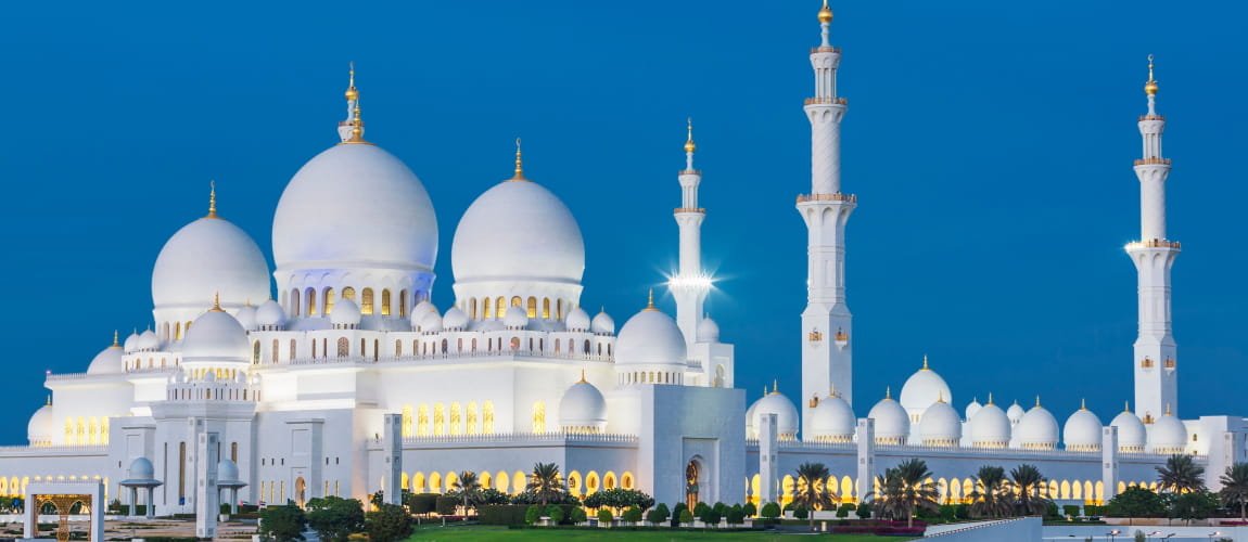 Sheikh Zayed Grand Mosque at night, beautifully lit, ideal for cultural sightseeing tours.