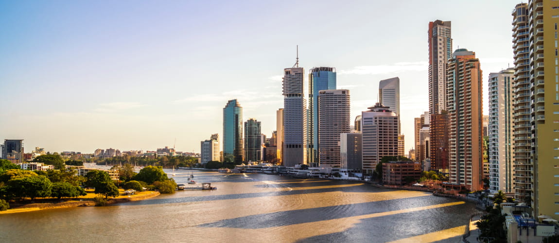 Brisbane’s riverfront cityscape during the day, perfect for luxury chauffeur experiences.