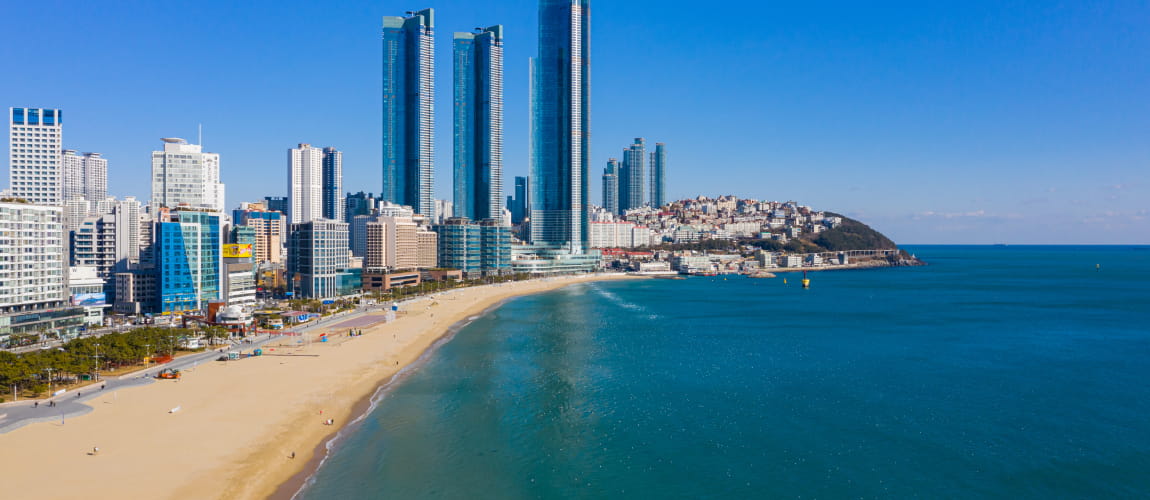 Aerial shot of Haeundae Beach and Busan skyscrapers, a prime spot for luxury travel.