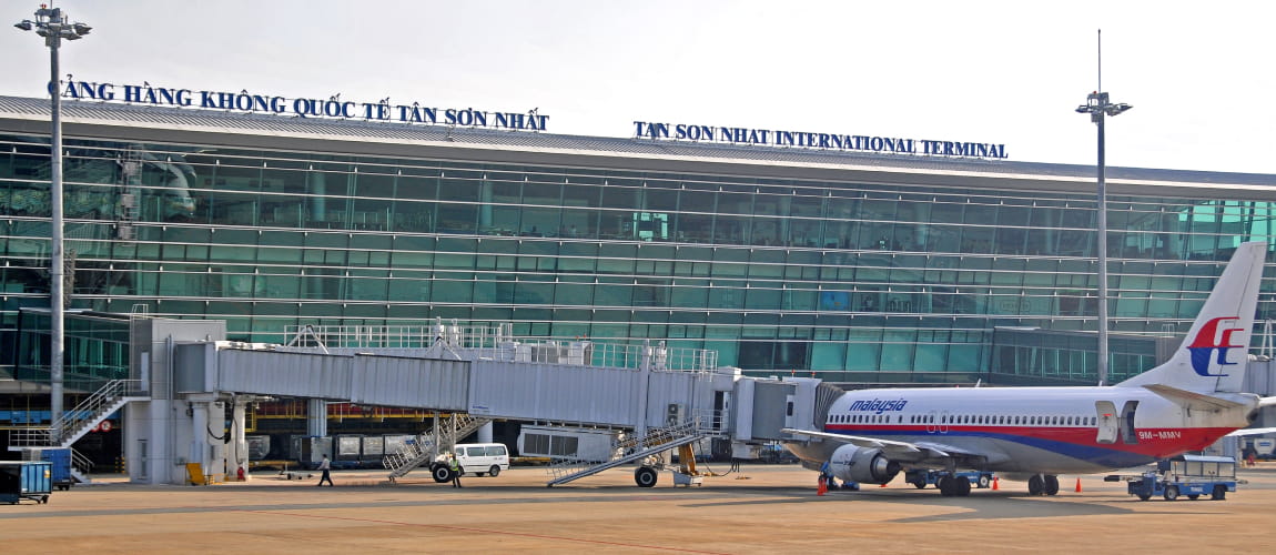 Tan Son Nhat International Airport with a docked plane, perfect for airport transfer services.