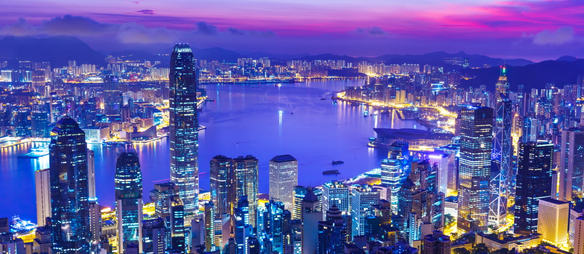 Victoria Harbour’s glowing skyline at night, ideal for luxury travel and city tours.