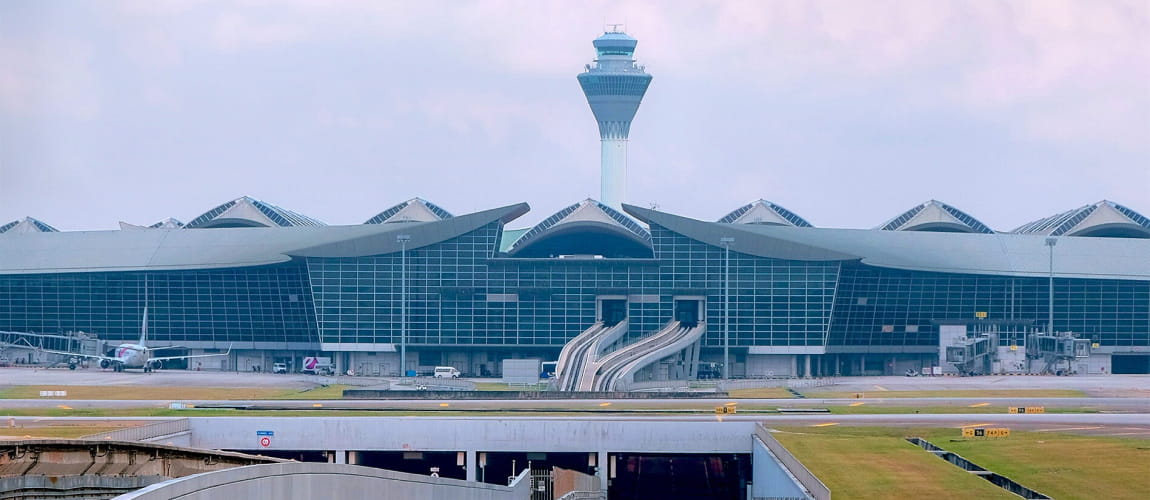 Kuala Lumpur International Airport terminal and control tower, highlighting the airport's modern architecture and extensive facilities.