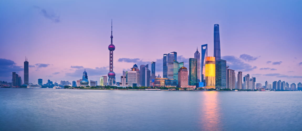 Pudong skyline at dusk with Oriental Pearl Tower, fitting for luxury travel and business services.