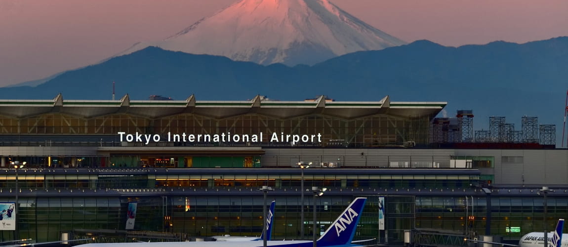 Mount Fuji at sunset behind Tokyo International Airport, perfect for premium transfer services.